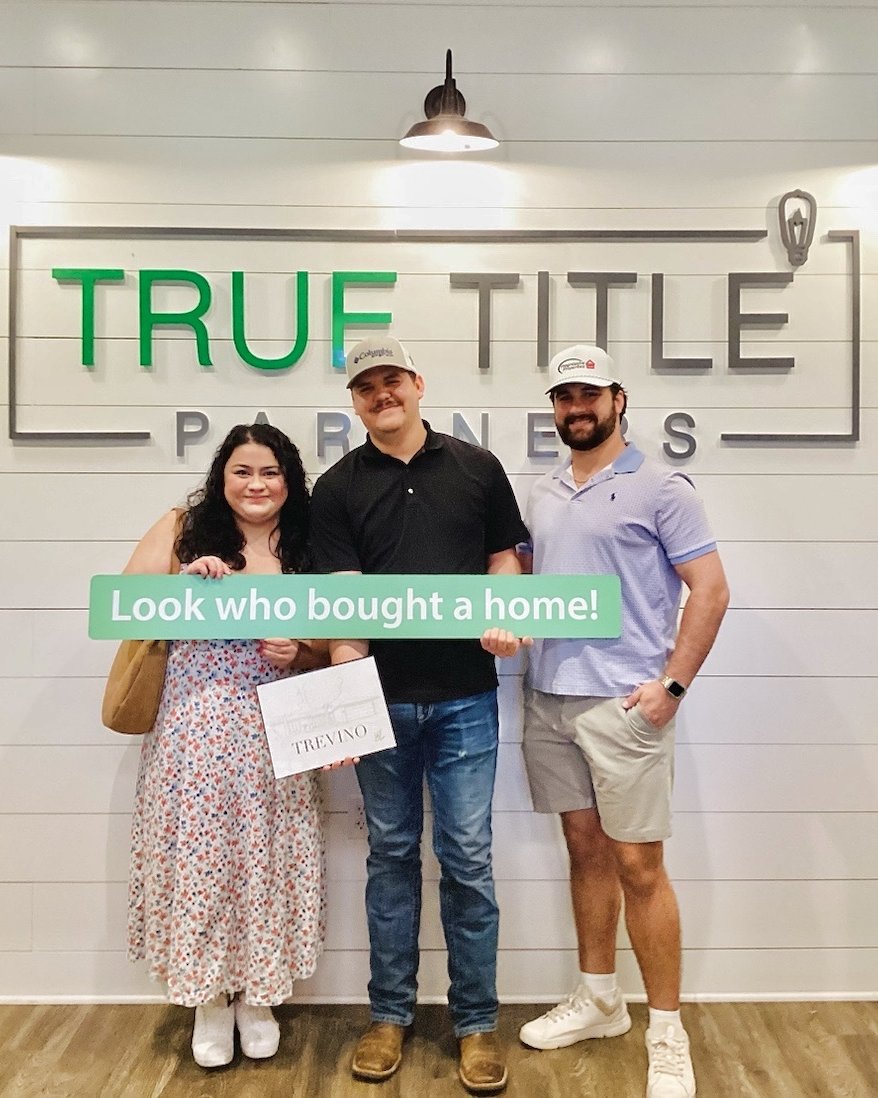 John Thomasson II with clients at their Lubbock home closing